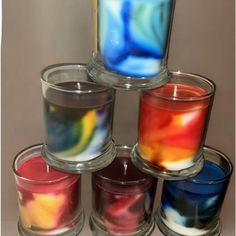 six candles are stacked in different colors