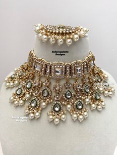 the necklace is adorned with pearls and other jewels