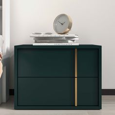 there is a clock on top of a green cabinet next to a white bed and nightstand