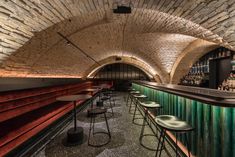 an underground bar with stools and tables