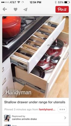 an open drawer with pots and pans on the bottom, in front of a stove