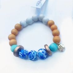 Features a mix of wood beads, acrylic beads, Audra Style™ print beads and signature AS brand charm. Casual Turquoise Jewelry With Wooden Beads, Casual Wooden Beads Stretch Bracelet For Beach, Casual Beach Stretch Bracelet With Wooden Beads, Casual Everyday Jewelry With Wooden Beads, Adjustable Wooden Beads Stretch Bracelet, Audra Style, Glass Bracelets, Bracelet Inspiration, Glass Bracelet