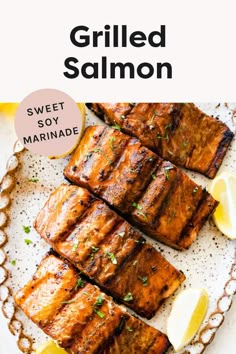 grilled salmon on a plate with lemon wedges