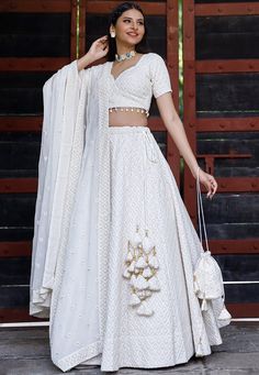 Faux Georgette Lehenga in White. This attire with Cotton Lining is Enhanced with Chicken Embroidery with Resham, Sequins work along with Fancy Tassels, Matching Potli and Can Can Net. Available with a Readymade Faux Georgette White Choli and a Faux Georgette Dupatta in White. The Readymade skirt will be provided. Lehenga Length is 40 inched.Do Note: Accessories shown in the image are for presentation purposes only and length may vary upto 2 inches.(Slight variation in actual color vs. image is p Lehenga Simple, Lehenga White, Chicken Embroidery, Fancy Tassels, Indian Bridesmaid Dresses, Function Dresses, White Lehenga, Simple Lehenga, Trendy Outfits Indian