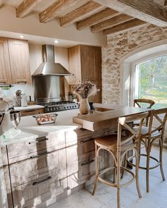 a kitchen with wooden cabinets and counter tops