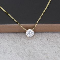 "14k Simulated Diamond Necklace | 6.0MM Cubic Zirconia Pendant | Solitaire Prong Setting Necklace | White Gold Cubic Zirconia Necklace | April Birthstone Necklace P R O D U C T 𝄪 D E T A I L S ✽ Metal: 14k Yellow Gold, White Gold & Rose Gold ✽ Chain Length: 14\" - 20\" (Classic Rolo Chain) ✽ Center Stone: 6.0 mm Cubic Zirconia (approx. 1.0ct) ✽ Made to Order M O R E 𝄪 B I R T H S T O N E 𝄪 N E C K L A C E S ✽ January | Garnet: https://etsy.me/3Whtt9N ✽ February | Amethyst: https://etsy.me/3jo Gold Solitaire Necklace With Diamond Cut Cubic Zirconia, Gold Solitaire Necklace With Prong Setting In Cubic Zirconia, Gold Solitaire Necklace With Vvs Clarity, Dazzling Gold Solitaire Necklace With Vvs Clarity, Yellow Gold Cubic Zirconia Round Cut Necklace, Gold Solitaire Necklace With Round Lab Grown Diamond Pendant, Gold Solitaire Moissanite Necklace, Gold Diamond Necklace With Lab Grown Diamonds, Gold Diamond Necklace With Round Pendant