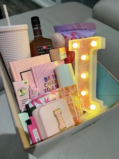 a car trunk filled with personal care items and makeup on top of a table next to a cup