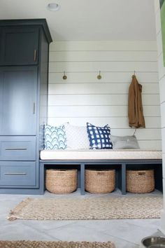 a bench with baskets underneath it in a room