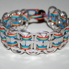 a rainbow bracelet is shown on a white surface