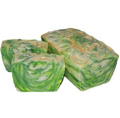 three pieces of green and yellow soap sitting on top of each other