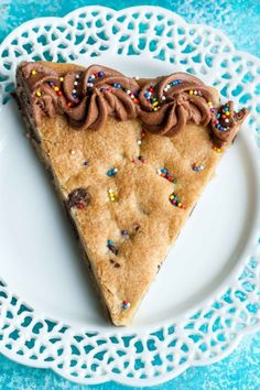 a slice of cake with chocolate frosting and sprinkles on a white plate