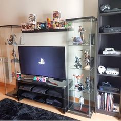 a living room filled with furniture and a flat screen tv on top of a glass shelf