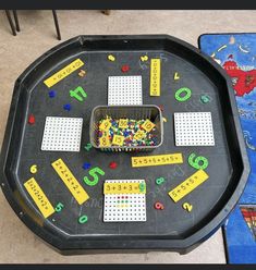 a play table with lots of numbers and magnets on the top for kids to use