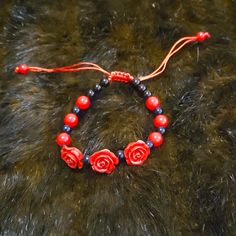 New Without Tags. Adjustable Bracelet. Fits Most Wrists. Adjustable Red Jewelry With Black Beads, Adjustable Red Beaded Bracelet, Casual Red Jewelry With Black Beads, Casual Red Bracelet, Adjustable Red Bracelets, Flowers Color, Black Bracelet, Black Bracelets, Adjustable Bracelet