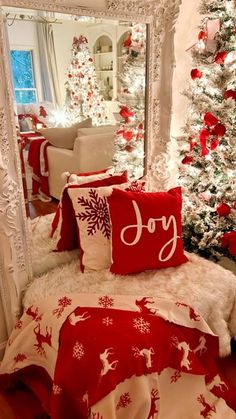 a bedroom decorated for christmas with red and white decor