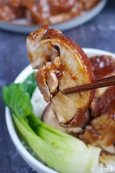 chopsticks sticking out of meat in a bowl