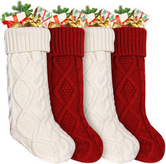 three red and white christmas stockings with bows