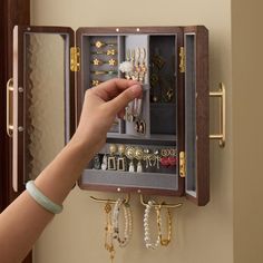 a person is holding an open jewelry box