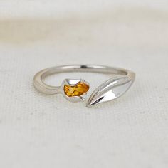 Sterling Silver Citrine Tulip Flower Leaf Detail Ring. Set with a pear shaped natural African yellow citrine. The ring is an adjustable design in two sizes. I'm a big fan of developing designs for adjustable rings. They give that bit of flexibility if your size varies with the seasons, as mine does, or convenience if you're buying a gift that it will fit the recipient. Citrine are associated with joy and energy. They are the birthstone for November. Finished with a commercial grade rhodium plate to give a high quality shine finish. Supplied in an Ojewellery presentation box, within a ribbon handled gift bag, complete with product information authenticity card with space for a gift message and a jewellery cleaning cloth to keep your jewellery in ready to wear condition. Our jewellery packag Bird Rings, Yellow Jewelry, Tulip Flower, Flower Leaf, Detailed Ring, Yellow Citrine, Citrine Ring, Tulips Flowers, Jewelry Packaging