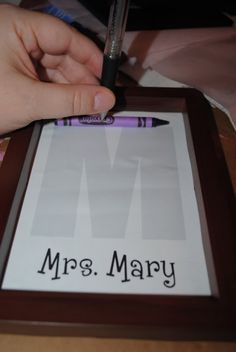 a person holding a pen and writing on a paper with the word mr & mrs mary