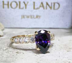 Don't miss this opportunity to own this beautiful gemstone ring crafted in 14k gold filled => Gemstone Type - Amethyst, Clear Quartz => Gemstone Cut - Faceted => Gemstone Size - 7*10 mm, 2.25 mm => Gemstone Shape - Pear Shape, Round Shape => Total Number of Gemstones - 9 => Metal Type - 14k Gold Filled (Tarnish Resistant And Nickel Free) - also available in 925 sterling silver * Please contact me for pricing on a sizes larger than 11 * ~ Feel free to ask me about custom made de Pear-shaped Vs Clarity Ring For Proposal, Yellow Gold Teardrop Jewelry For Proposal, Teardrop 14k Gold Promise Ring, Gold Teardrop Rings For Proposal, Teardrop Halo Setting Promise Ring, Pear-shaped 14k Gold Gemstone Wedding Ring, Fine Jewelry Teardrop Crystal Ring, Solitaire Pear-shaped Jewelry For Proposal, Pear-shaped Center Stone Jewelry For Promise Ring