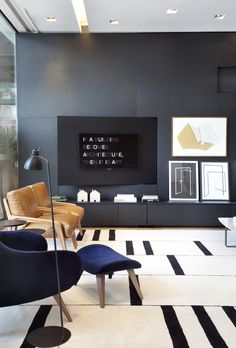 a living room with black walls and white flooring