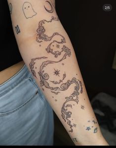 a woman's arm with tattoos on it, and an image of a horse