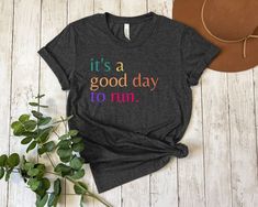 It's a Good Day to Run T-Shirt, Motivational Running Shirt, Colorful Graphic Tee for Runners, Comfortable Cotton Black Tee, Runner Gift Idea How to Order 1. Explore Our Photos: Check out all the photos of the products you are interested in. 2. Review Size and Color Chart: Ensure you refer to the size and color chart provided. 3. Select Your Size: Choose your size from the dropdown menu. 4. Pick Your Color: Select your preferred color from the dropdown menu. 5. Choose Quantity: Decide the number Marathon Shirts, Gifts For Runners, Running Shirts, Cozy Fits, Sports Shirts, Good Day, Unisex Fashion, Black Tee, Short Sleeve Tee