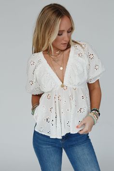 Elevate your style with the timeless and charming, Let Love Embroidered Top with details that add a touch of romance to your everyday looks! Whether dressed up or down you're going to love this unique top because it features: So pretty and unique Cotton fabric with floral eyelet details throughout Flattering deep v - neckline with cute gathered fabric details Cute short puff sleeves with elastic sleeve closures Pointed gathered babydoll - style center seam Lined along the bust for added coverage White V-neck Feminine Embroidered Top, White Cotton V-neck Embroidered Top, Chic V-neck Embroidered Cotton Top, White V-neck Peasant Top With Floral Embroidery, White Embroidered Top With Short Sleeves, Relaxed Fit, Gathered Fabric, Boho Essentials, Bralette Outfit, Babydoll Style