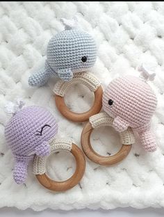 three crocheted toys sitting on top of a white blanket