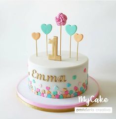 a birthday cake decorated with hearts and candles