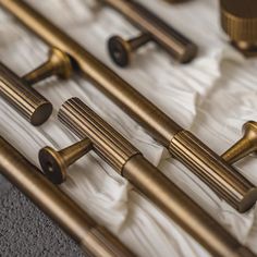 the handles and pulls of an antique brass door handle set on a white sheeted bed