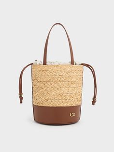 Luxury Rectangular Straw Bucket Bag, Luxury Beige Bucket Bag With Intrecciato Weave, Luxury Woven Leather Straw Bucket Bag, Luxury Straw Bucket Bag With Woven Leather, Luxury Straw Bucket Bag With Bamboo Handle, Luxury Woven Rectangular Bucket Bag, Luxury Rectangular Woven Bucket Bag, Rectangular Natural Bucket Bag With Intrecciato Weave, Luxury Bucket Straw Bag