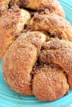 some sugared doughnuts are on a blue plate