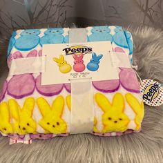 a close up of a stuffed animal on a bed with a label that says peeps