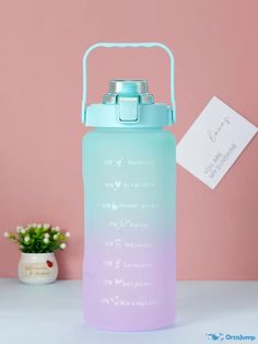 a blue and purple water bottle sitting on top of a table