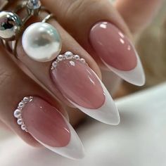 a woman's hand with some pink and white nails