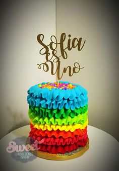 there is a cake that has been decorated with rainbow ruffles and the word sefiia on top