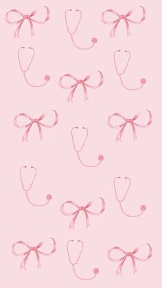 many pink bows are attached to the side of a white wall with hearts and a stethoscope on it