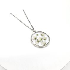 Baby's Breath Pressed Wildflower Necklace | Unique Gift for Her | Gypsophila Resin Necklace | Dried Wildflowers | Handmade Jewelry 》DESCRIPTION * Real Pressed Baby's Breath Flower encased in high quality UV resin * Silver Plated Zinc Metal Alloy Pendant Frame  - Diameter: 25mm in diameter - Thickness: 2mm * Necklace Length: 18 inches 》STAINLESS STEEL CHAIN: * Stainless Steel Necklace Chain * Stainless Steel Jump Ring *Stainless Steel Clasps 》All items, personalized or not are done by HAND with l Nature-inspired White Birth Flower Necklace, Delicate Round Flower Necklace With Pressed Flowers, Delicate Round Pressed Flower Necklace, White Birth Flower Round Pendant Necklace, Nature-inspired White Necklace With Pressed Flowers, White Nature-inspired Necklace With Pressed Flowers, White Flower Necklace With Pressed Flowers, White Flower Pendant Necklace With Pressed Flowers, Delicate White Birth Flower Necklace