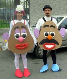 two people in costumes are standing next to a car and one is wearing a potato head