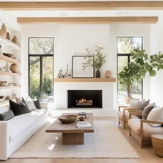 a living room filled with furniture and a fire place in the middle of a room