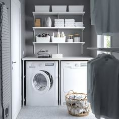 a washer and dryer sitting in a room next to each other with shelves on the wall