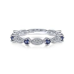 an 18k white gold stacking ring with blue sapphire stones