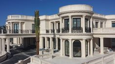 a large white building with many balconies