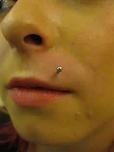 a close up of a person with a nose piercing