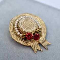 Vintage CINER hat brooch. Textured gold-tone metal with enamel and tiny faux pearls. Designer hat brooch pin. Brooch size: 3.9x3 cm/1.5x1.2 inches. Mark: Ciner. Condition: very good vintage. Maybe you want to see other brooches too: https://www.etsy.com/shop/VintageVoyageLT?ref=seller-platform-mcnav&section_id=39171293 You can write me a message if you have any questions. Glad you visited my store! Have a great time! Gold Party Brooch Pin, Vintage Gold Hats For Wedding, Elegant Gold Mini Hats For Gift, Elegant Gold Mini Hats For Gifts, Vintage Gold Hat For Formal Occasions, Vintage Gold Pins For Party, Vintage Gold Mini Hats For Party, Vintage Gold Wedding Hat, Gold Vintage Hats For Vintage Events