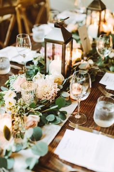 the table is set with flowers and candles