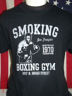 "Joe Frazier Gym Tribute Tee \"Unlimited Americana Tees are my Art form to honor the sport of Boxing, these are all original designs created by me. If you see any design of my collection anywhere else, I guarantee it's a knock off. For ownership claims and/or compensation feel free to contact me here. Thank you for visiting my site.\" \"Unlimited American Boxing Tees, for the fight fan in us all.\" Professionally Screen Printed Heavy Duty Gildan Brand 100% Cotton Tee Sizes Small to 4 XL - $25.00 Band Merch T-shirt With Graphic Print For Sports, Hip Hop T-shirt With Letter Print For Sports Season, Hip Hop Crew Neck T-shirt For Sports Events, Hip Hop Graphic Print T-shirt For Sports Season, Hip Hop T-shirt With Graphic Print For Sports Events, Hip Hop Graphic T-shirt For Sports Events, Hip Hop Sports T-shirt With Screen Print, Band Merch Sports T-shirt With Crew Neck, Band Merch Crew Neck T-shirt For Sports