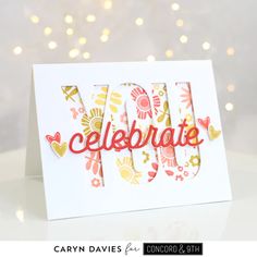 a handmade card with the word celebrate written in red and yellow on white paper